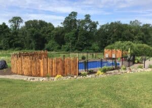 Wooden and metal combo fence around backyard pool